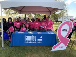 Langley employees gather by their tent for a photo before walking in support of breast cancer research.